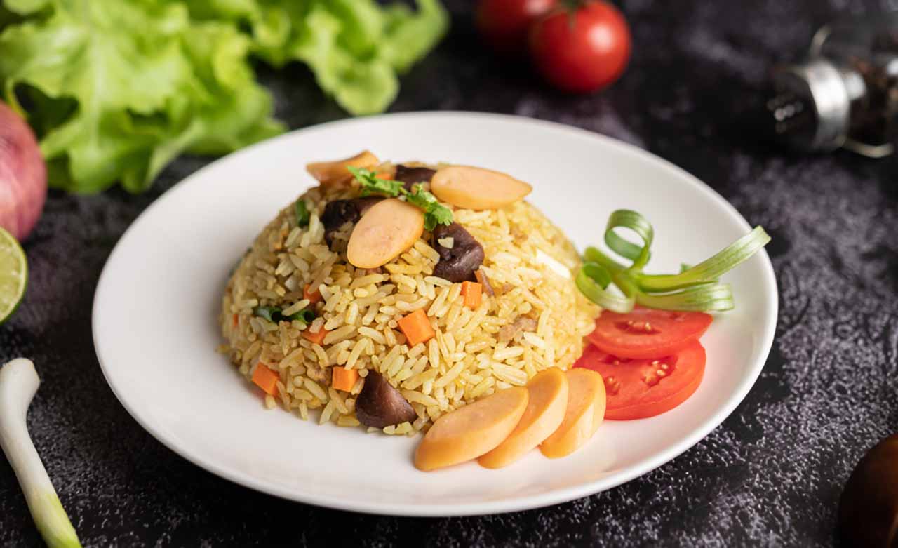 Fried rice with tomatoes carrots mushrooms plate